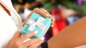 woman holding jewelry box with Christmas background credit Shutterstock