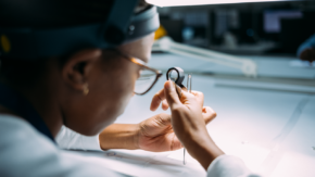 Student analysing polished diamond with loupe and tweezers in GSS Diamond Academy, Botswana image