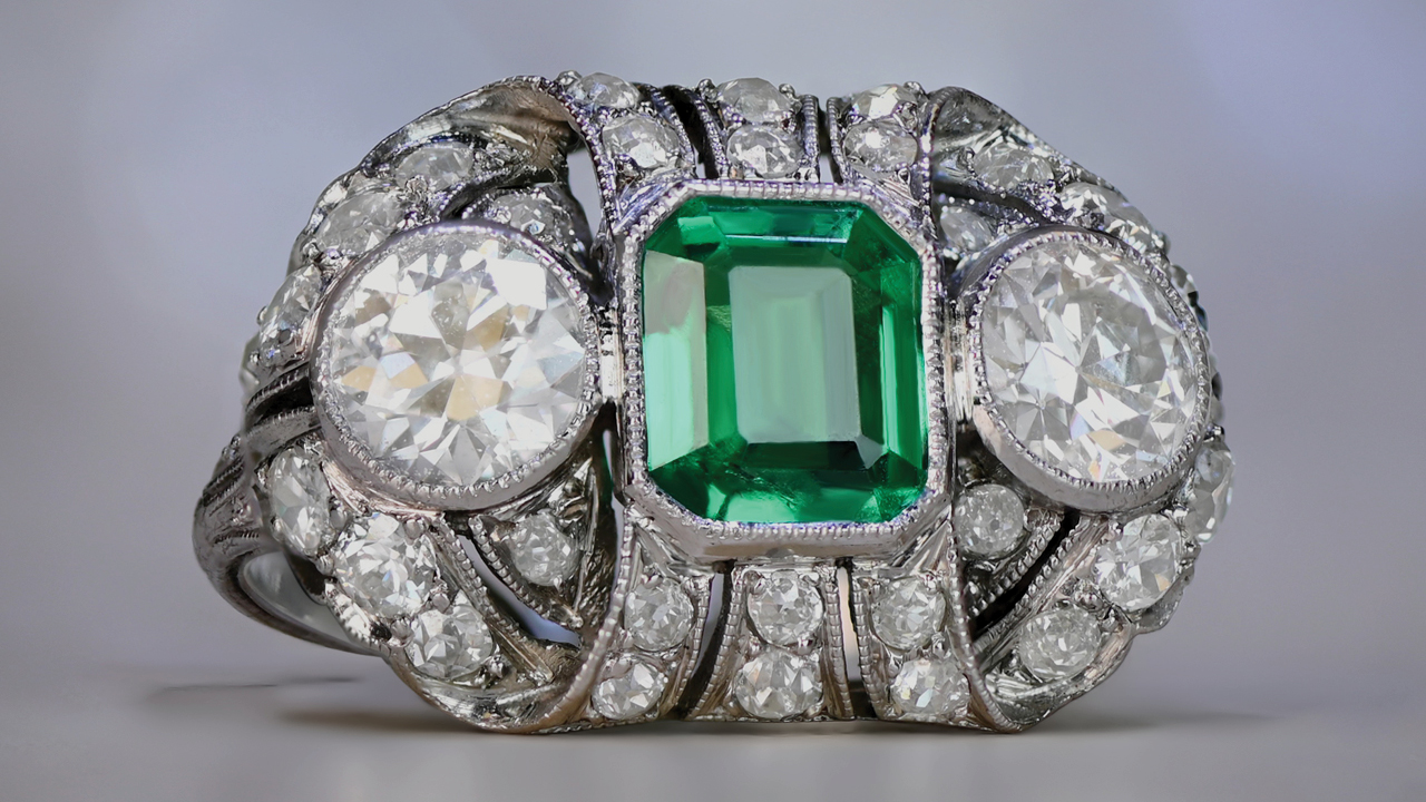 Image of antique three-stone ring with a Colombian emerald and old European-cut