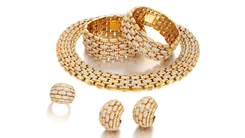 gold and diamond Cartier set comprising a necklace, two bracelets, a pair of ear clips, and a ring image