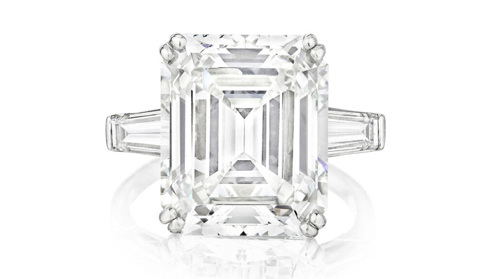 Emerald-cut diamond center stone between two tapered baguette-cut diamonds ring at Bonhams image