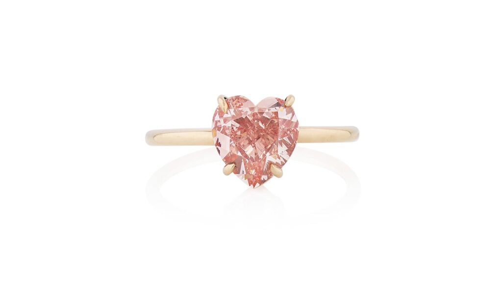Ring featuring a heart-shaped fancy-vivid-orangey-pink, VS2-clarity diamond center stone at Phillips image