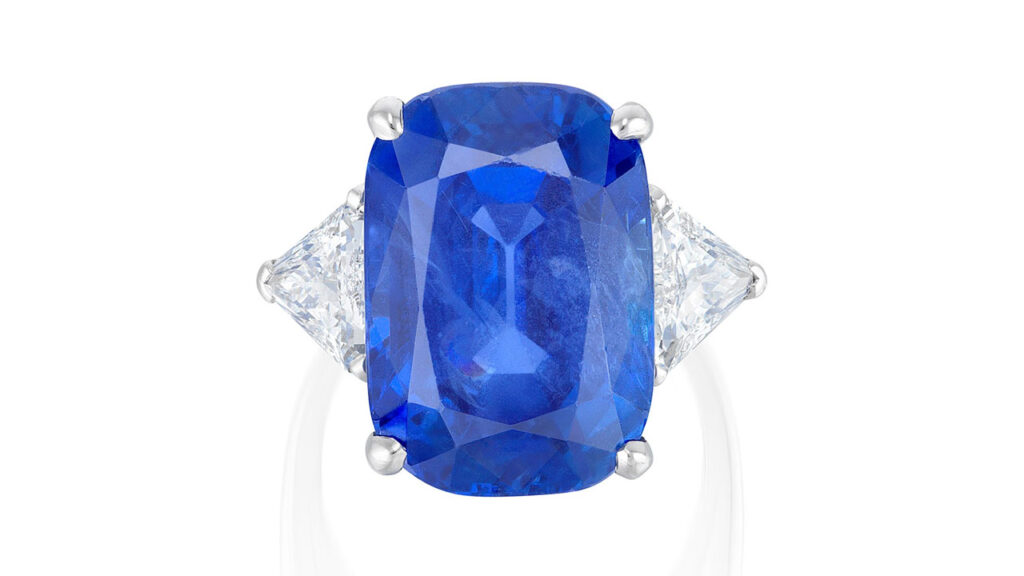 A Cartier ring sporting a cushion-shaped, 20.70-carat Burmese sapphire between two triangular-shaped diamonds image