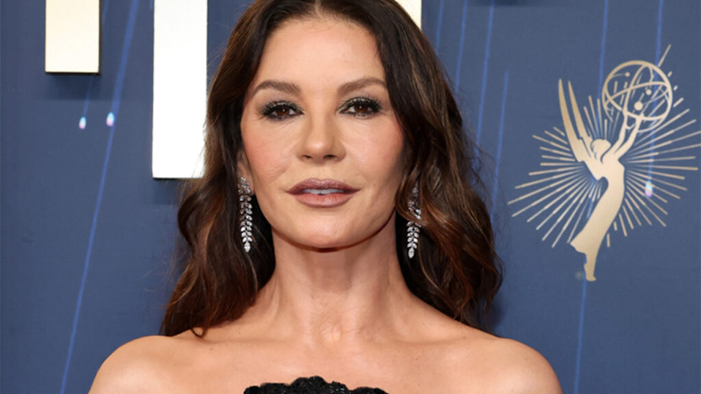 Catherine Zeta-Jones wearing Stephen Silver Fine Jewelry’s marquise-cut diamond chandelier earrings, a three-stone ring and a 5.59-carat oval diamond bypass ring image