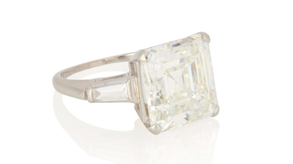 Ring with a square emerald-cut, 6.49-carat diamond flanked by two tapered baguette diamonds at John Moran image