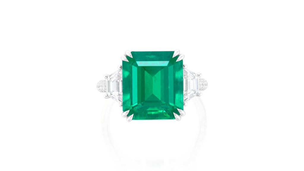 Ring features a step-cut, 7.15-carat Colombian emerald between two trapeze-cut diamonds at Phillips image