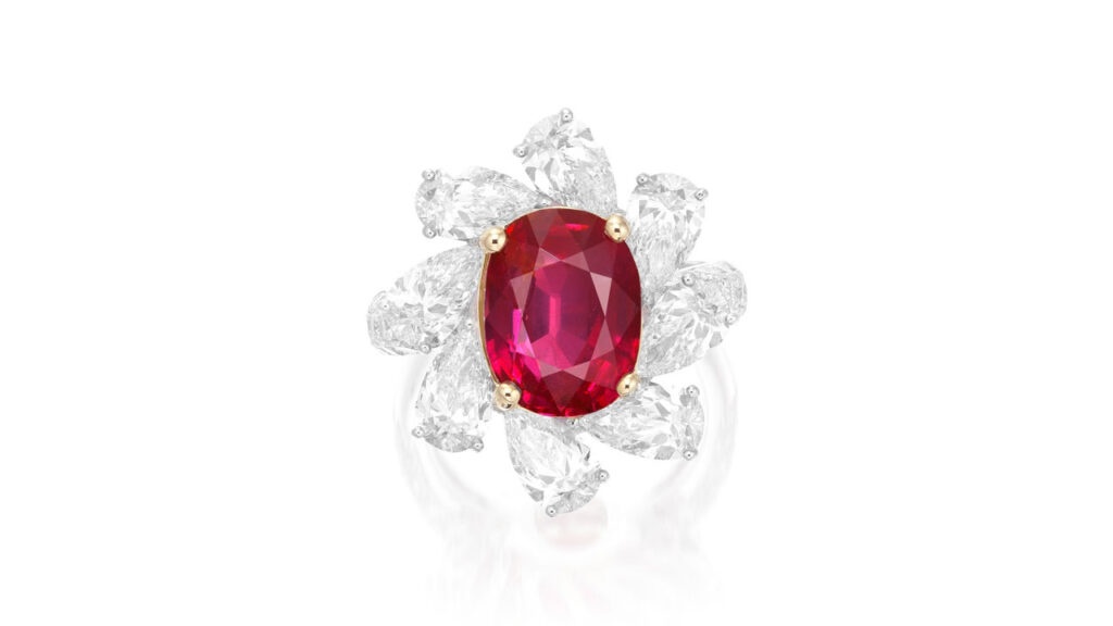 Ring bears an oval, 5.71-carat Burmese ruby in a frame of pear-shaped diamonds at Phillips image