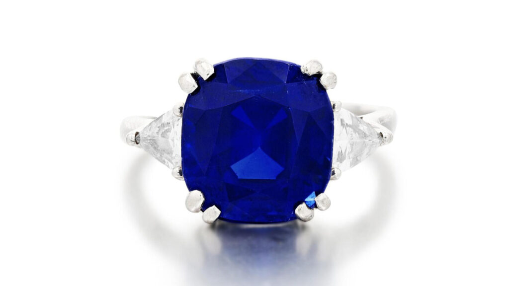 This ring has a cushion-shaped, 10.68-carat Kashmir sapphire between two triangular diamonds by Sotheby's image