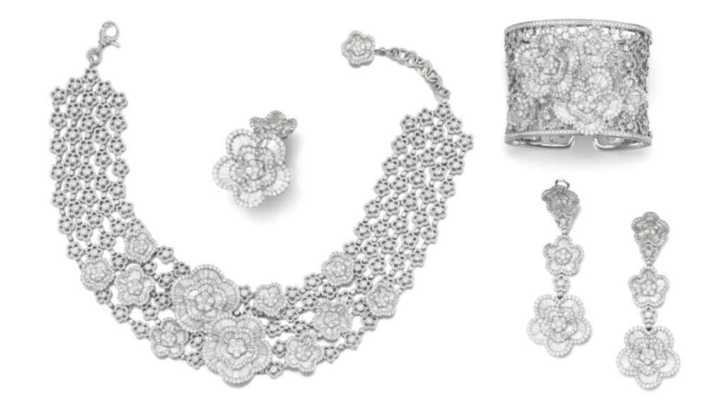 This lot by Schreiner includes a floral-design necklace with tapered-baguette and brilliant-cut diamonds, and earrings, a ring and a bangle, all with similar motifs by Sotheby's image
