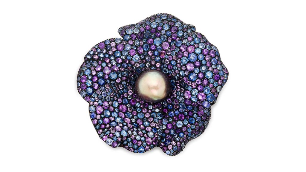 JAR clip-brooch is designed as a wild rose, the petals pavé set with round amethysts and sapphires at Sotheby's image.