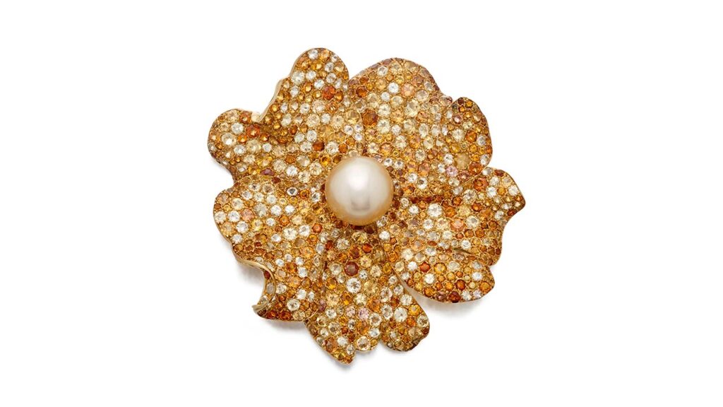 Wild rose clip-brooch by JAR centers a button-shaped pearl, surrounded by petals pavé set with round citrines and yellow sapphires by Sotheby's image