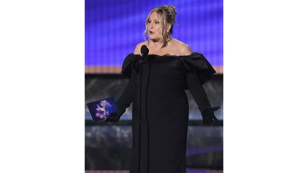 Jennifer Coolidge wearing Hanut Singh earrings featuring golden pearls and black enamel with her black evening gown image