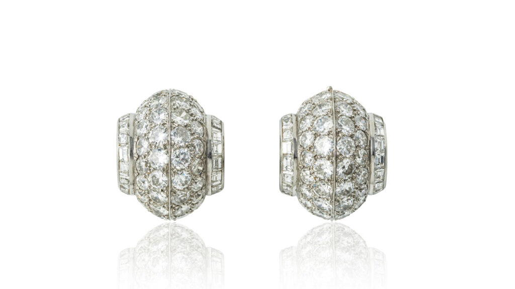 Van Cleef & Arpels bombé design ear clips from around 1935, bearing pavé-set brilliant-cut diamonds between baguette stones at Bonhams image