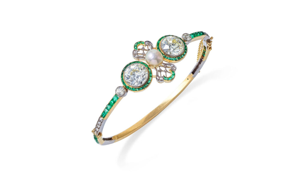 This bracelet bears a cultured pearl between two brilliant-cut diamonds — a 3.22-carat, N to R color and a 3.32-carat, N to R color stone. Also featuring calibré-cut emeralds and rose-cut diamonds at Bonhams image