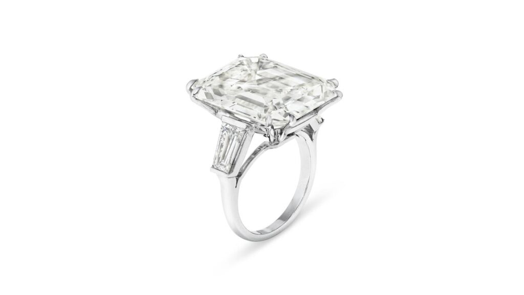 A ring bearing an emerald-cut, 24.99-carat, J-color, VS1-clarity diamond with baguette-cut diamond shoulders at Christie's image