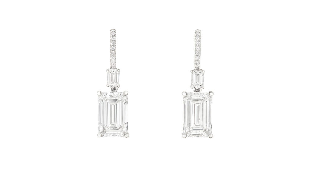 A pair of earrings comprising emerald-cut diamonds, one a 5.03-carat, D, VS1 and the other a 5.02-carat, E, VVS1 stone, both suspended from emerald-cut and round diamonds at Christie's image