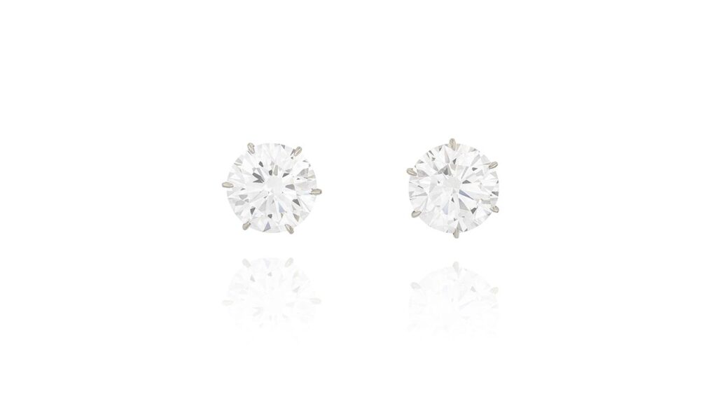 A pair of earrings consisting of brilliant-cut, D-color, VVS1-clarity diamond studs weighing 8.28 and 8 carats at Phillips image
