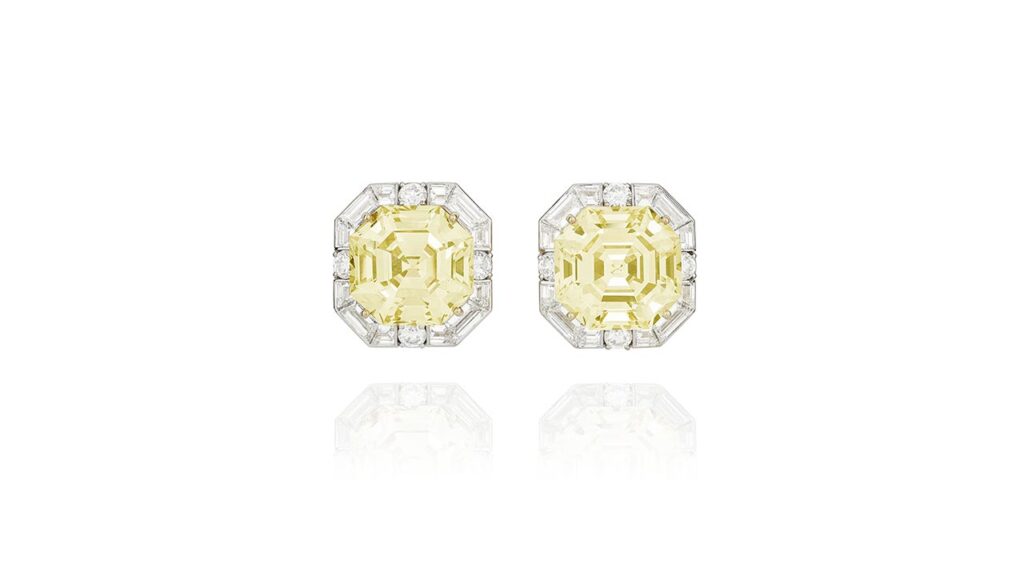 A pair of Graff earrings with octagonal step-cut, fancy-yellow diamond center stones weighing 21.38 and 20.33 carats surrounded by diamonds at Phillips image