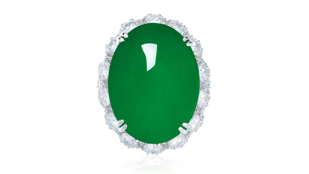 A ring with a jadeite cabochon in a circular-cut diamond surround at Poly Auction image