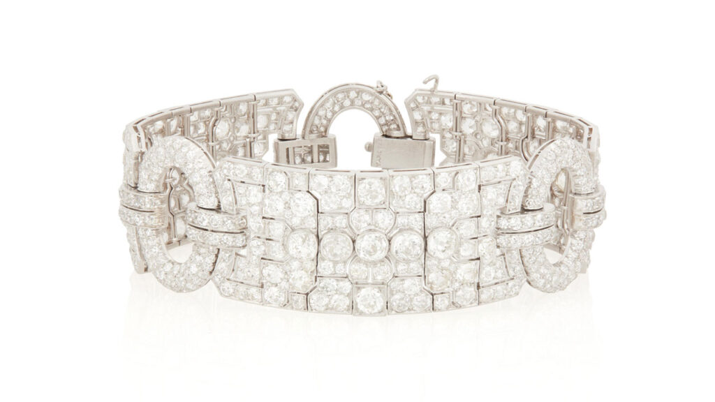 Raymond Yard designed this Art Deco diamond bracelet from around 1930. It features three ornate panels connected by oval circular frames with a total of 26 carats of old European- and old mine-cut diamonds at John Moran image