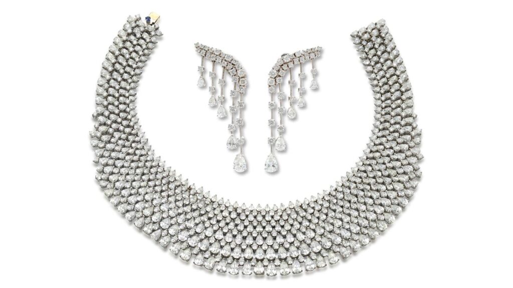 This three-piece diamond demi-parure by Schreiner comprises a choker with pear-shaped diamonds throughout, enhanced with brilliant-cut stones — 140.62 carats in total — along with a pair of fringe-style pendant earrings by Sotheby's image
