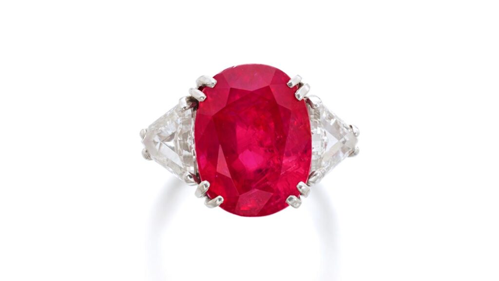 A ring with a cushion-shaped, 12.78-carat Burmese ruby between triangular diamonds at Sotheby's image