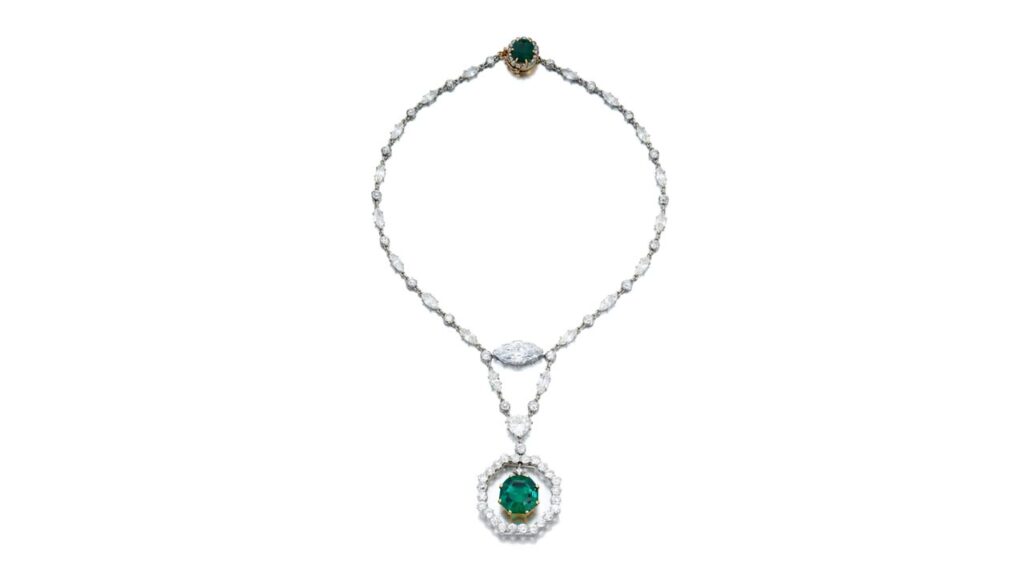 This Cartier necklace sports an octagonal step-cut, 11.78-carat Colombian emerald with an old mine-cut diamond surmount, swing-set within an old European-cut diamond frame. The necklace features a marquise-shaped, 5.54-carat, D-color, VS2 diamond at SOtheby's image