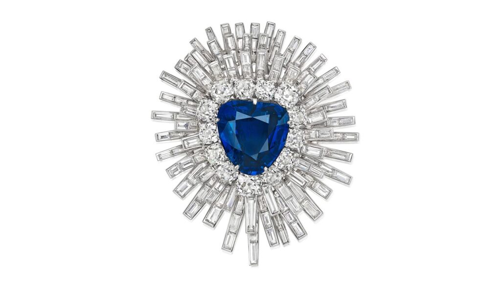 This brooch centers a pear-shaped, 20.82-carat Burmese sapphire with an old European- and old mine-cut diamond surround, in a detachable sunburst-style frame accented with baguette-cut diamonds at Bonhams image