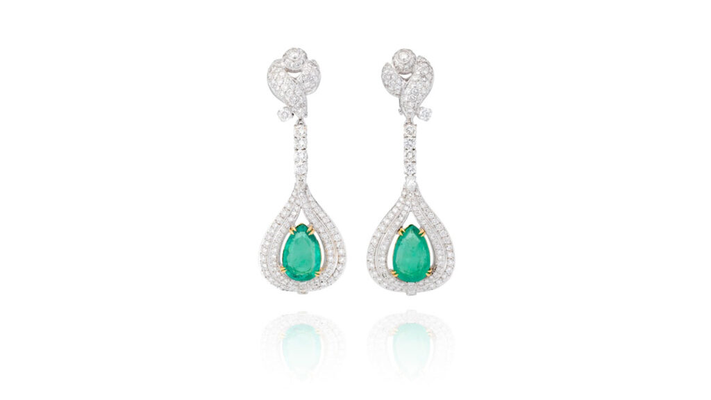 A pair of emerald earrings, each has a pear-shaped Colombian emerald, one weighing 5.11 and the other 5.17 carats, accented with around 8 carats of pear-shaped, brilliant-cut and tapered baguette diamonds at Phillips auction image