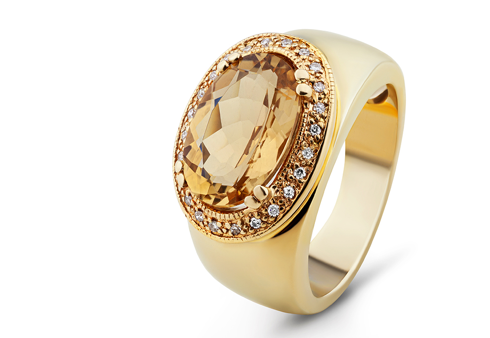 Gold ring featuring a citrine gemstone surrounded by diamonds image
