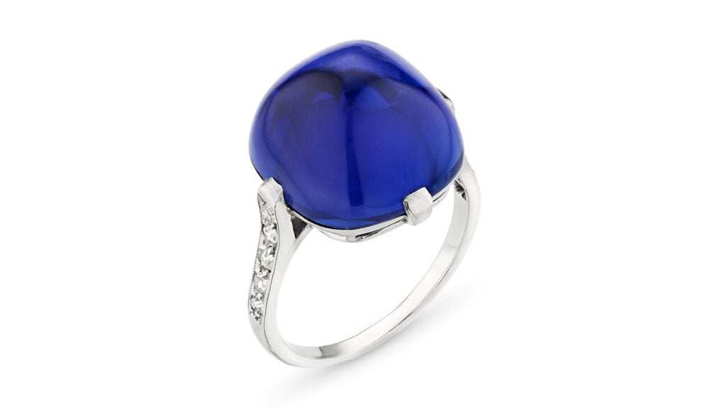 This Art Deco Cartier ring from around 1925 centers the 17.66-carat Rockefeller Kashmir sapphire, a sugarloaf cabochon on a band with single-cut diamonds at Christie's image