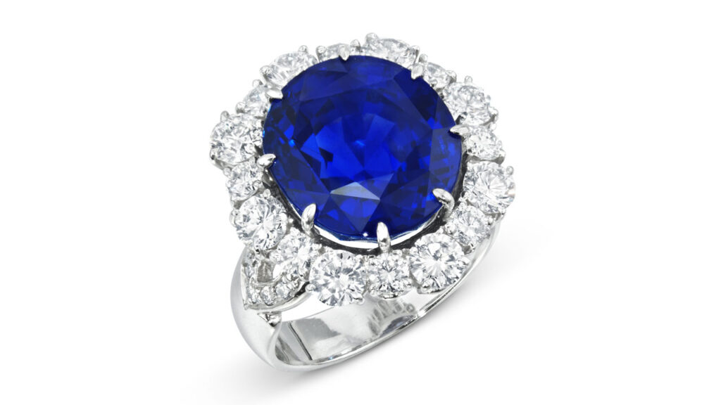 This oval-cut, 12.21-carat Ceylon sapphire in a ring with a border of round diamonds at Christie's image