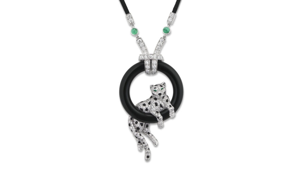 This Cartier pendant sports a diamond panther on an onyx hoop, with onyx spots and pear-shaped emerald eyes at Christie's image