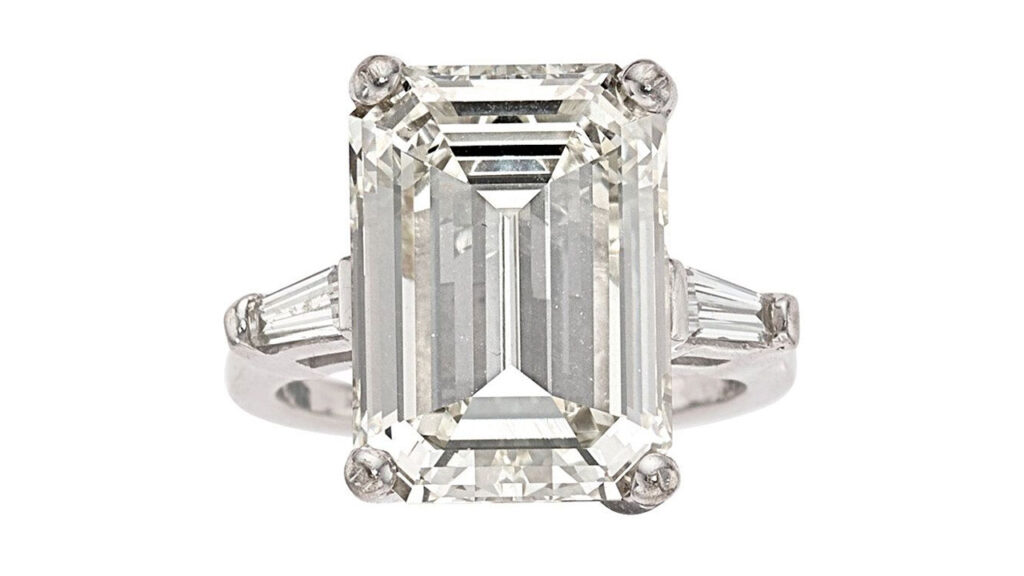 This ring centers an emerald-cut, 9.69-carat, K, VVS2 diamond with two additional baguette diamonds at Heritage Auction image