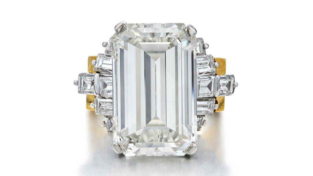 This ring features an emerald-cut, 13.01-carat, J-color, VS2 diamond with baguette-diamond accents and a removable gold jacket at Sotheby's image