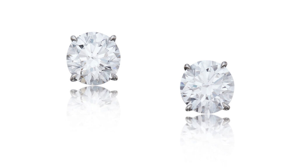 These earrings feature two round, D-color diamonds, one a VVS2 stone weighing 3.20 carats, and the other a 3.33-carat VVS1 at Sotheby's image