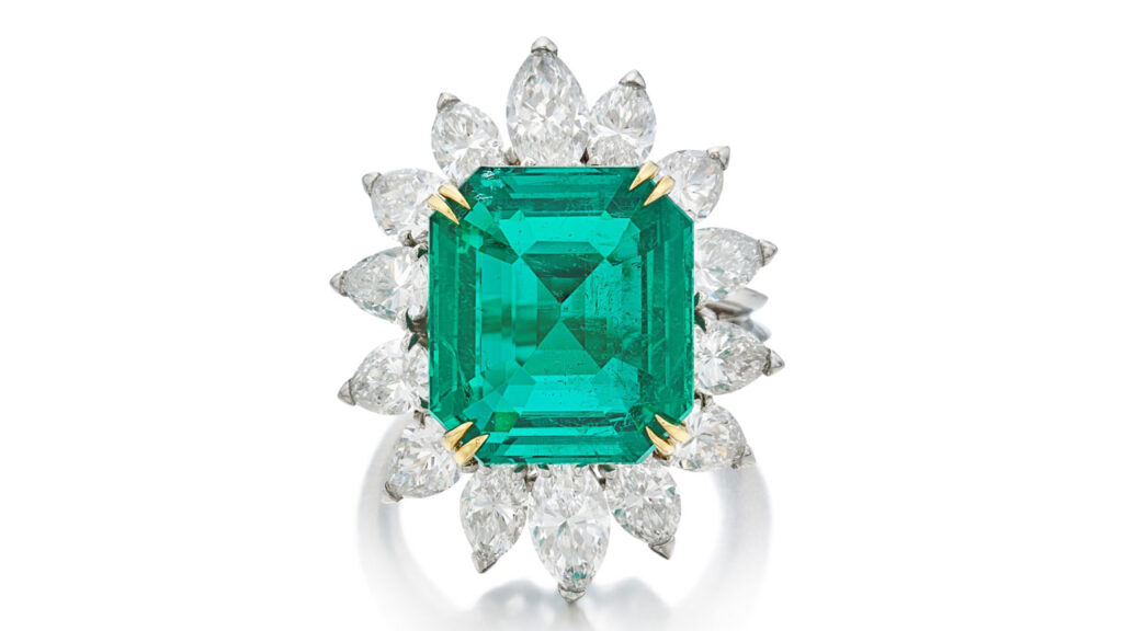 This Boucheron ring features an emerald-cut, 7.88-carat Colombian emerald with 14 pear- and marquise-shaped diamonds surrounding it at Sotheby's image