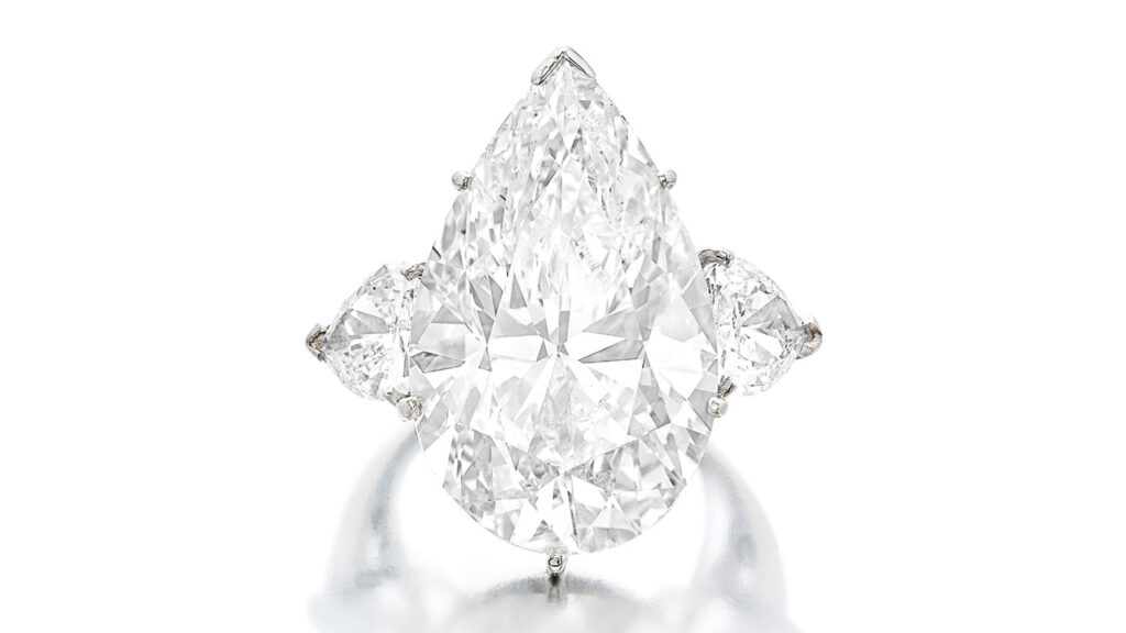 From the collection of philanthropist Geri Brawerman, this ring has a pear-shaped, 19.74-carat, H, SI1 diamond and pear-shaped diamond side stones at Sotheby's image