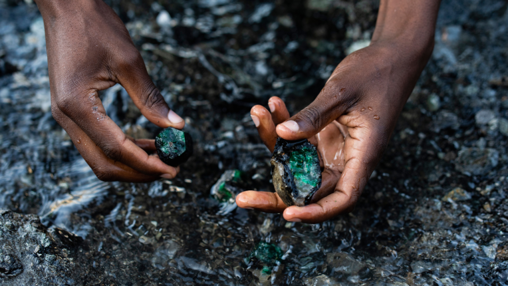 Hands holding rough emeralds at the Kagem mine in Zambia image