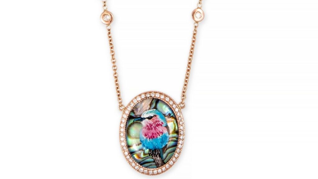 An abalone pendant by Jacquie Aiche with a miniature portrait of a bird image