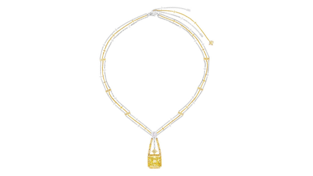 This necklace sports a cut-cornered square modified brilliant-cut, 20.04-carat, fancy-intense-yellow, VS1-clarity diamond, framed by brilliant-cut diamonds of yellow-tint. It hangs from a surmount and link-chain necklace set with an array of diamond cuts, including yellow-hued stones at Phillips image