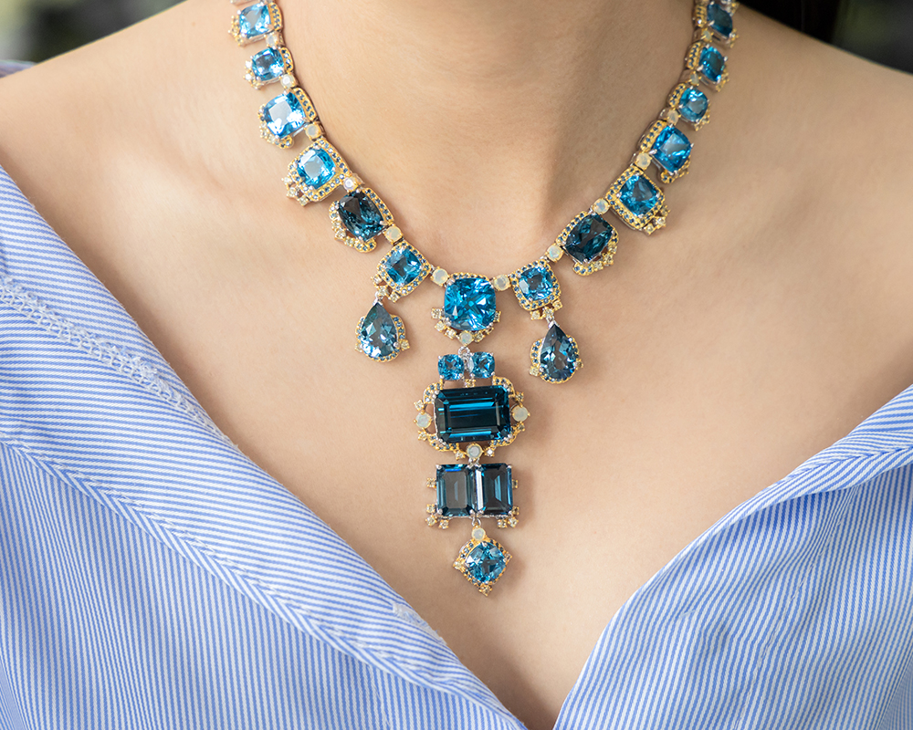 Gold necklace with assortment of blue hue aquamarine stones image