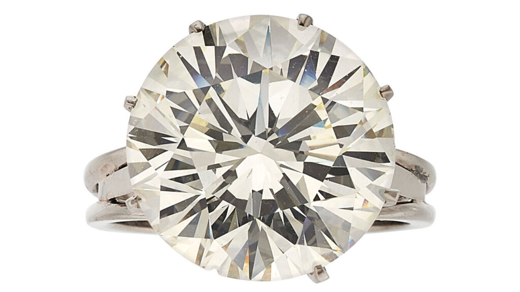A ring centering a round brilliant-cut, 12.90-carat, M, VS2 diamond at Heritage Auctions image