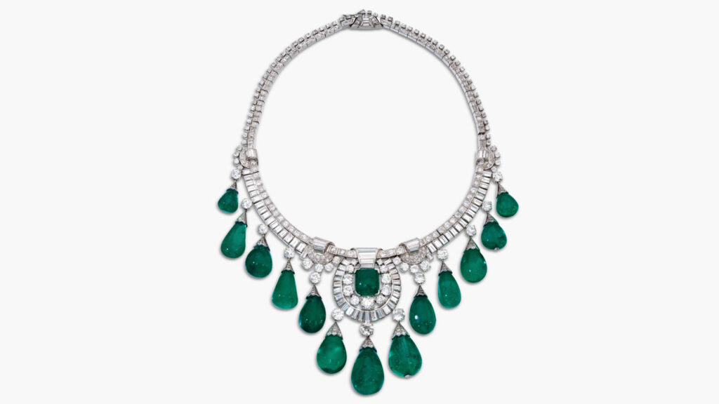 A necklace featuring a graduated fringe of 13 drop-shaped Colombian emeralds weighing between 11.38 and 57.52 carats and centering an 11.56-carat cabochon emerald in a frame of baguette, old mine-, old European- and single-cut diamonds at Sotheby's image
