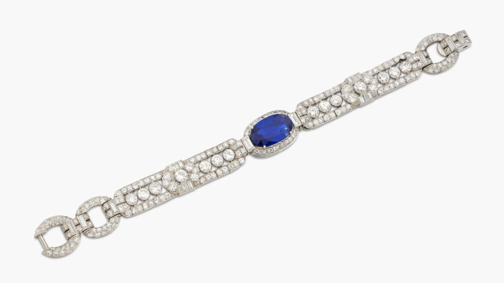 A Cartier bracelet from around 1950 stars an oval, 7.04-carat Kashmir sapphire bordered by brilliant-cut diamonds, within an openwork geometric baguette and brilliant-cut diamond design at Sotheby's image