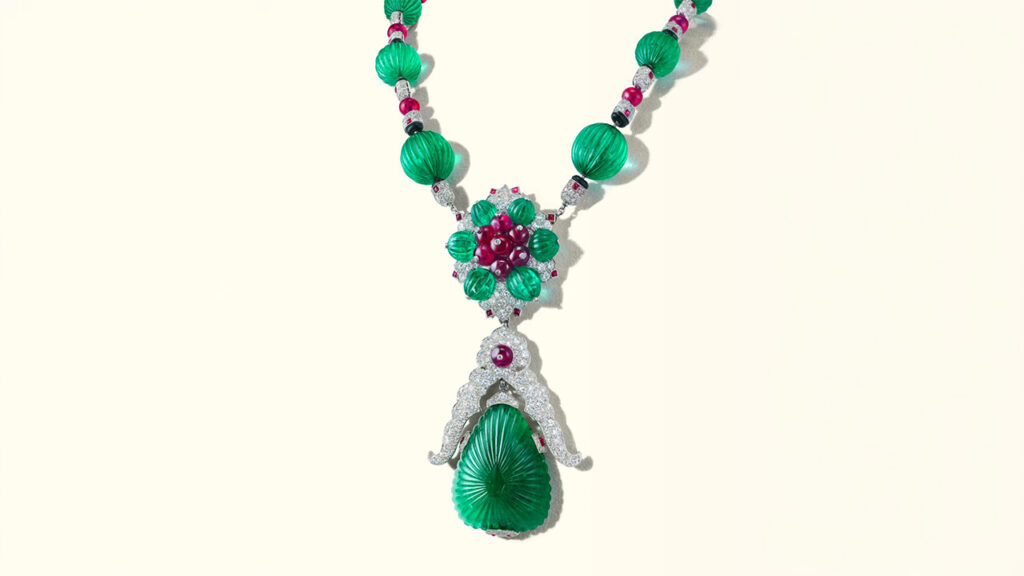 A Van Cleef & Arpels pendant necklace that detaches into brooches. The piece contains carved emeralds, ruby beads and buff top rubies, round and single-cut diamonds, and onyx beads at Christie's image