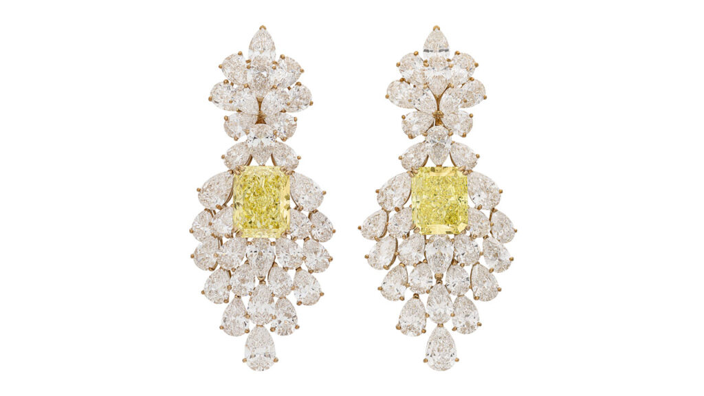 Van Cleef & Arpels made these earrings, each containing a cushion rectangular modified brilliant cut diamond — one a 19.33-carat, fancy-vivid-yellow, and the other an 18.03 carat, fancy-intense-yellow — with pear-brilliant-cut diamonds weighing 2.60, 2.11 and 2.09 carats at Christie's image