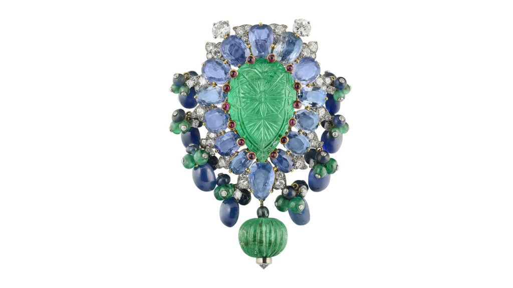 From Cartier, this Tutti Frutti clip brooch features carved emerald, emerald and sapphire beads, cabochon and oval-shaped sapphires, cabochon rubies, and round and single-cut diamonds at Christie's image