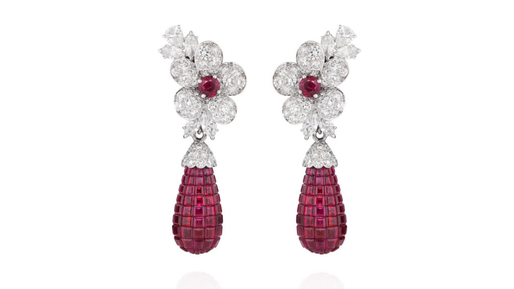 A pair of Van Cleef & Arpels earrings, each sporting a detachable drop-shaped pendant with calibré-cut rubies. These suspend from a floral design featuring pear- and marquise-shaped and brilliant-cut diamonds and accented with a circular-cut ruby at Phillips image