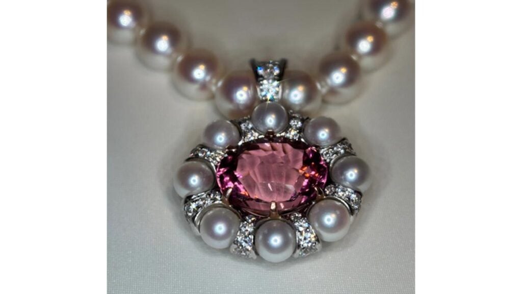 A 12.63-carat pink tourmaline set in 14-karat rose gold with 2.70 carats of diamond rondels and akoya pearls suspending from a strand of pearls, Jewelers of America image
